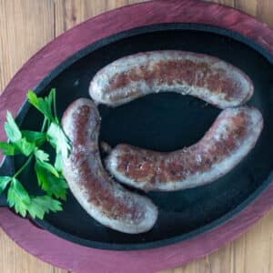 Goose sausage on a cast iron pan.
