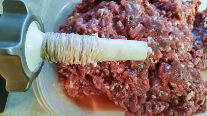 Casings loaded onto the sausage tube.