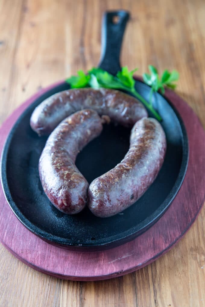 Cooked sausage on wooden board.