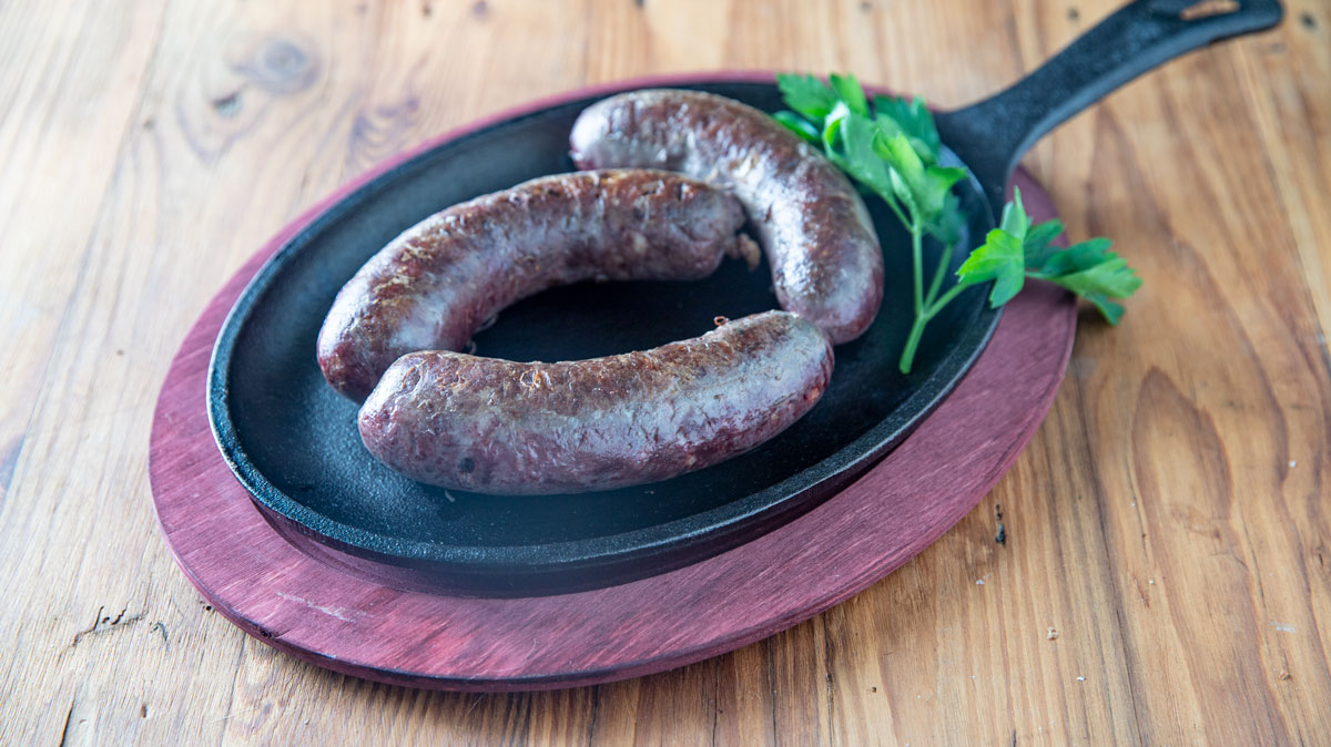 Goose sausage on a wooden board.