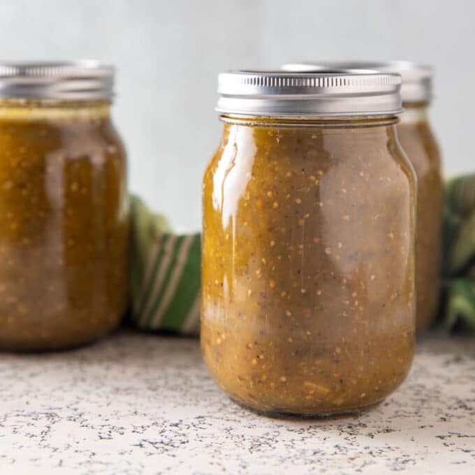 Green tomato sauce in jars.