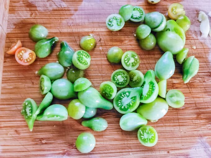 Green tomatoes cut to fit into juicer.