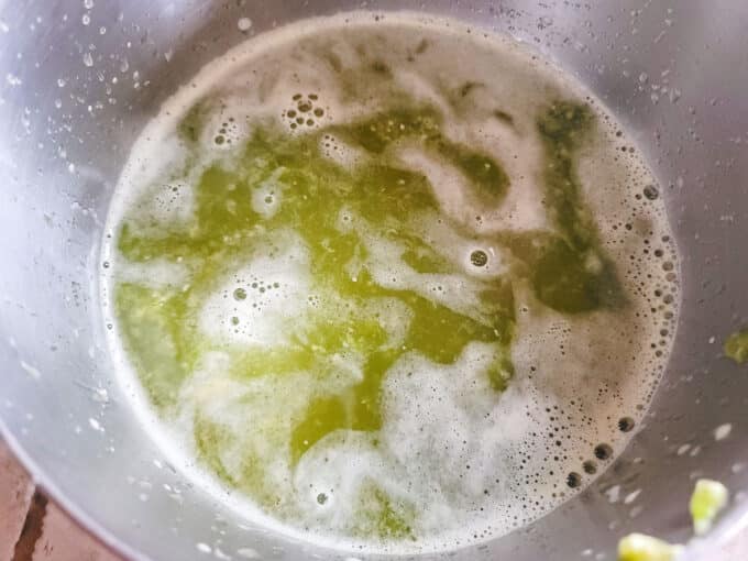 Green tomato juice in a large bowl.
