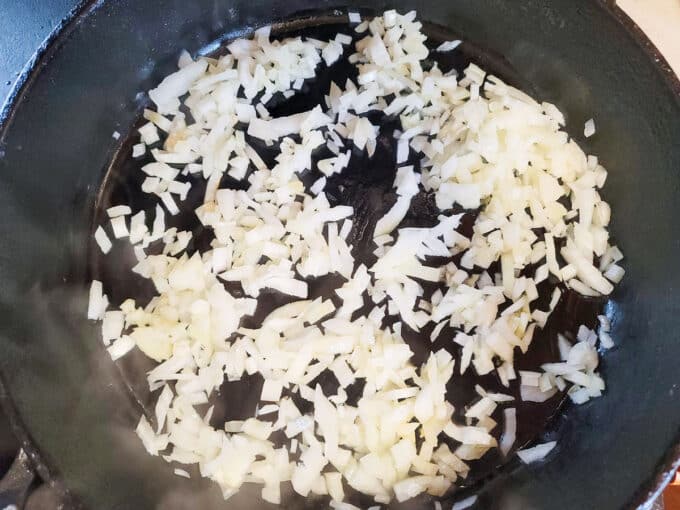 Chopped onion in cast iron pan, softening.