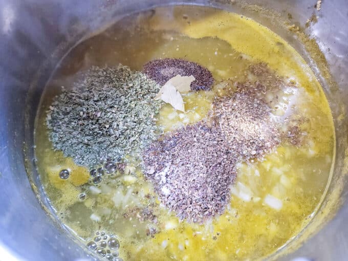Garlic, onion and spices added to tomato juice in large pot.