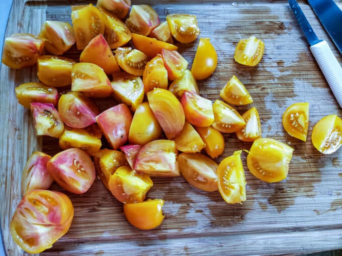 Chopped tomatoes on cutting board.