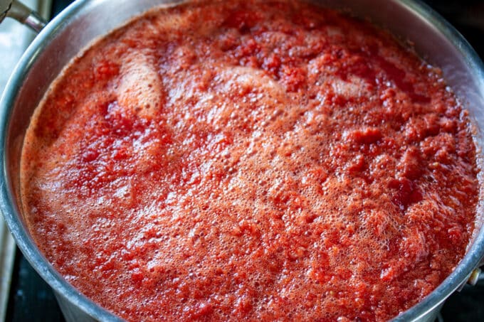 Large pot full of tomato juice.