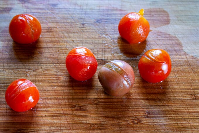Peeling the skins off of the tomatoes.