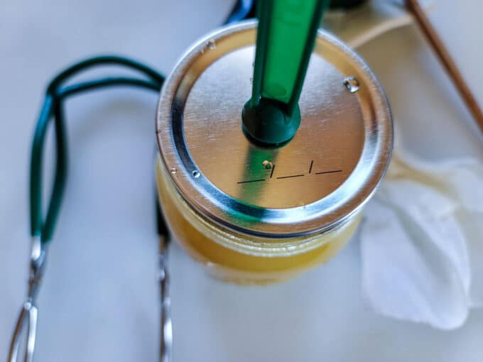 Adding lid with a lid lifter.