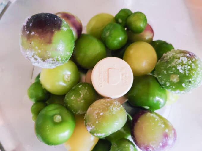 Tomatillos in food processor bowl.