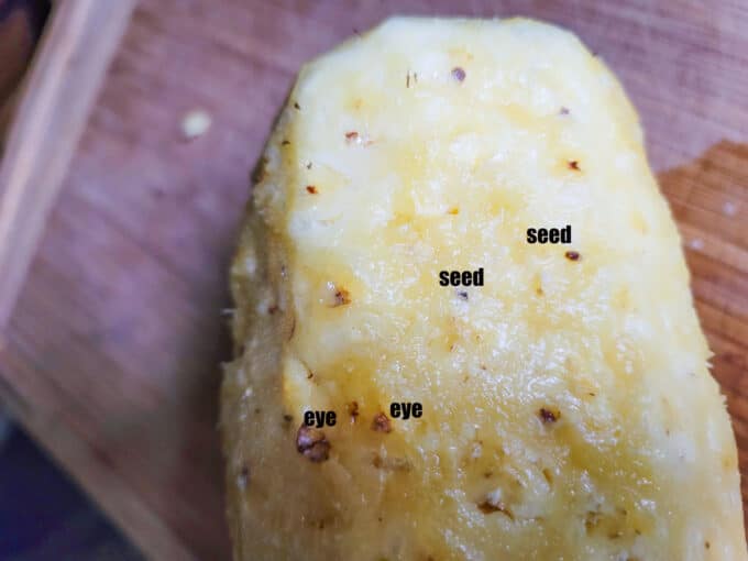 Identifying the seeds and eye of the peeled pineapple.
