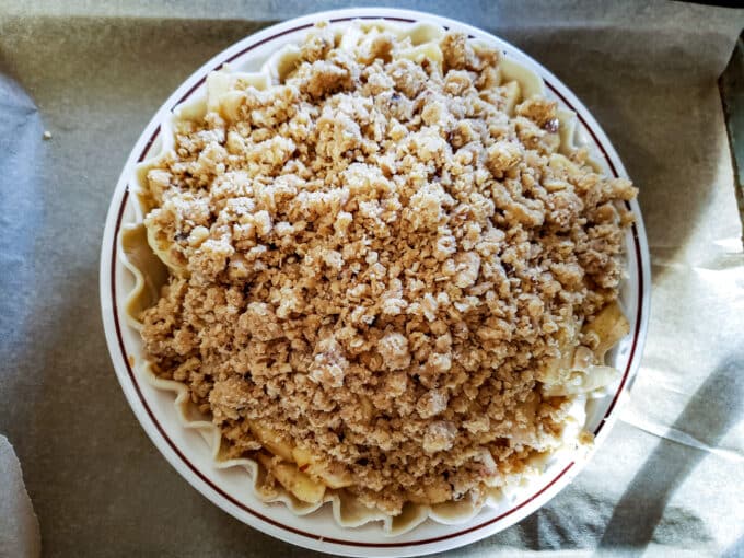 Crumb topping added on top of the apples in the pie crust.