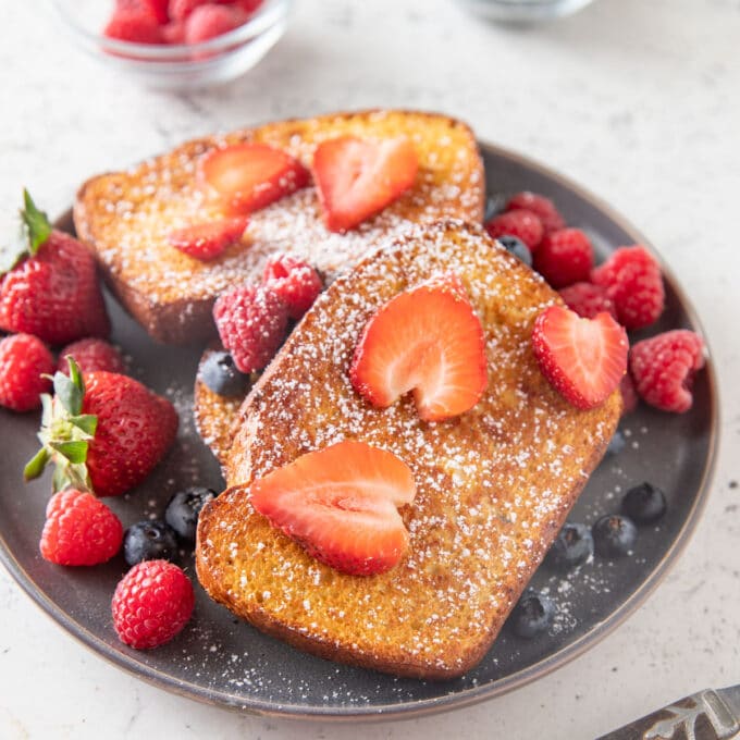 French toast on a plate with fresh berries.