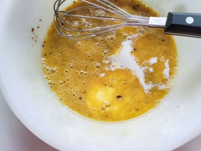 Milk added to the whisked eggs.