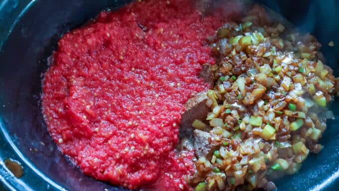 Diced tomato added to pan.