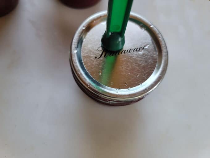 Adding the lid with a lid lifter.