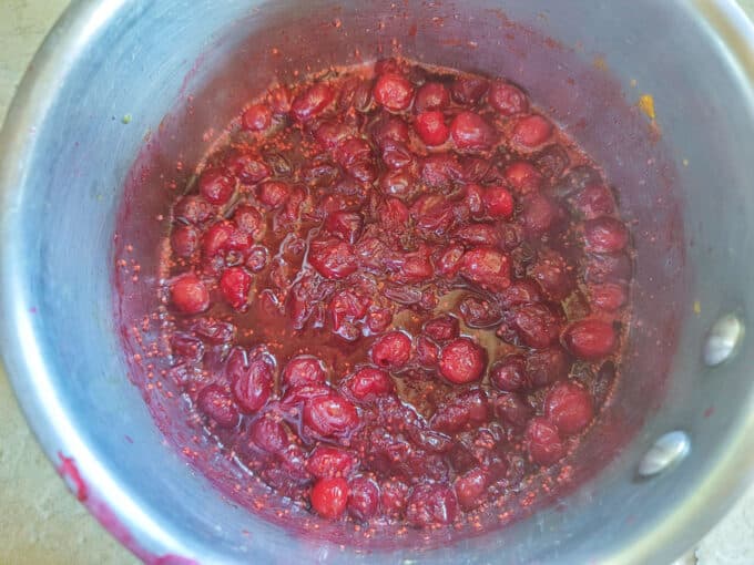 Cranberries cooking in pan.