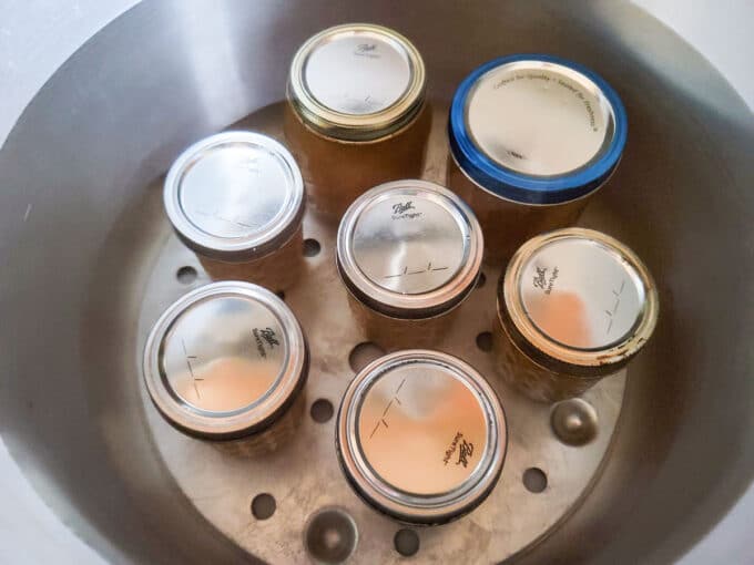 Jars in the canning pot covered with water.