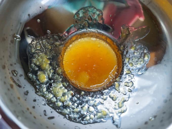 Canning funnel in a jar with pineapple jam.
