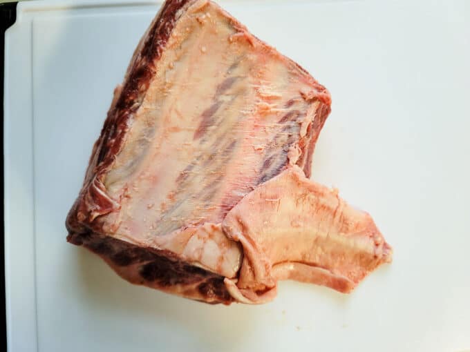 Trimming the meat on a white board.