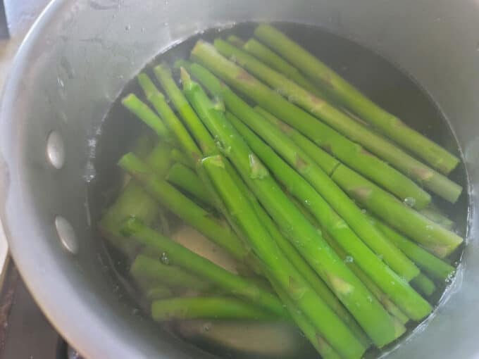 Blanching asparagus in a large pot.