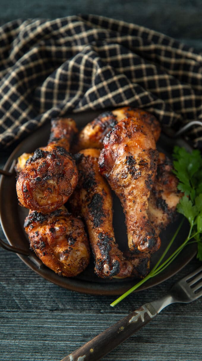 Browned chicken on a black tray.