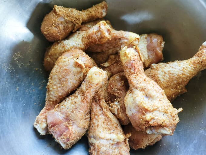 Drumsticks in a large metal bowl.