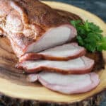 Sliced smoked pork loin with smoke ring.