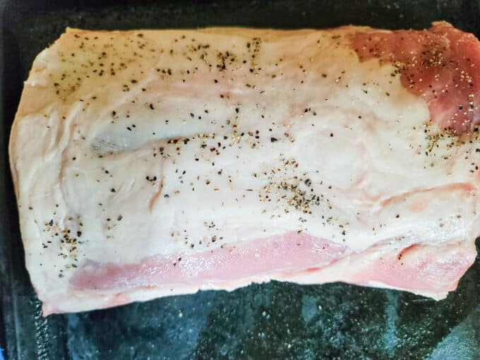 Salt and pepper sprinkled onto roast.