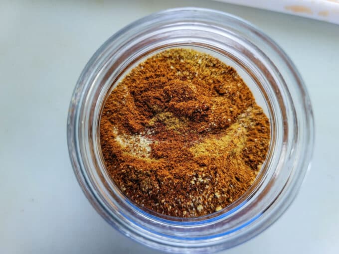 Spices added to a jar to mix.