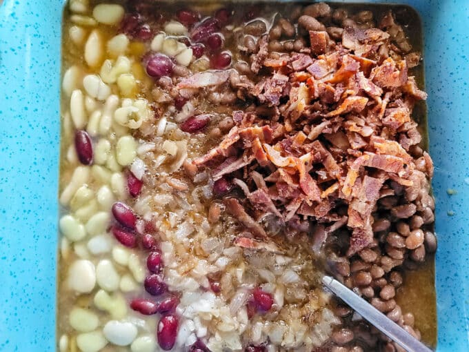 Onions, bacon, and vinegar mixture added to the casserole dish.