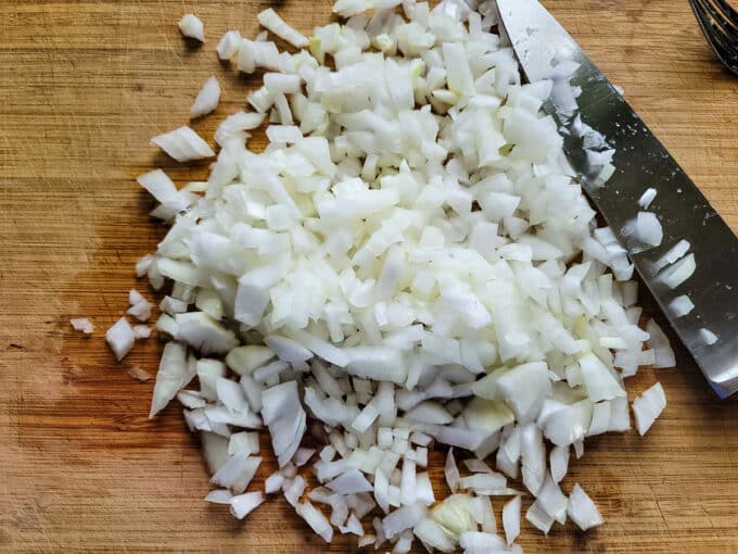 Diced onion on bamboo board.