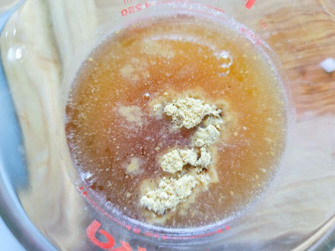 Spices mixed with vinegar in a measuring cup.
