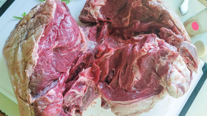 Boneless roast opened up on a cutting borad.