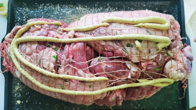 Mustard poured onto the roast.