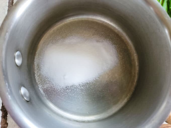 Sugar added to small saucepan.
