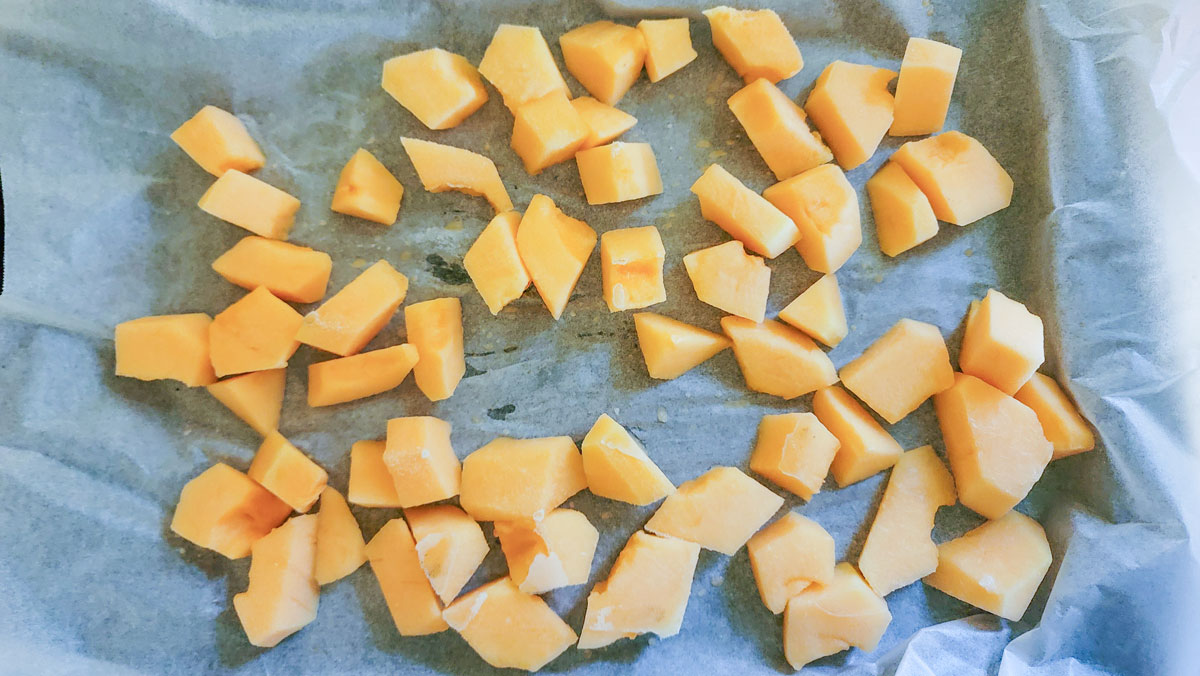 Frozen cantaloupe on the baking sheet.
