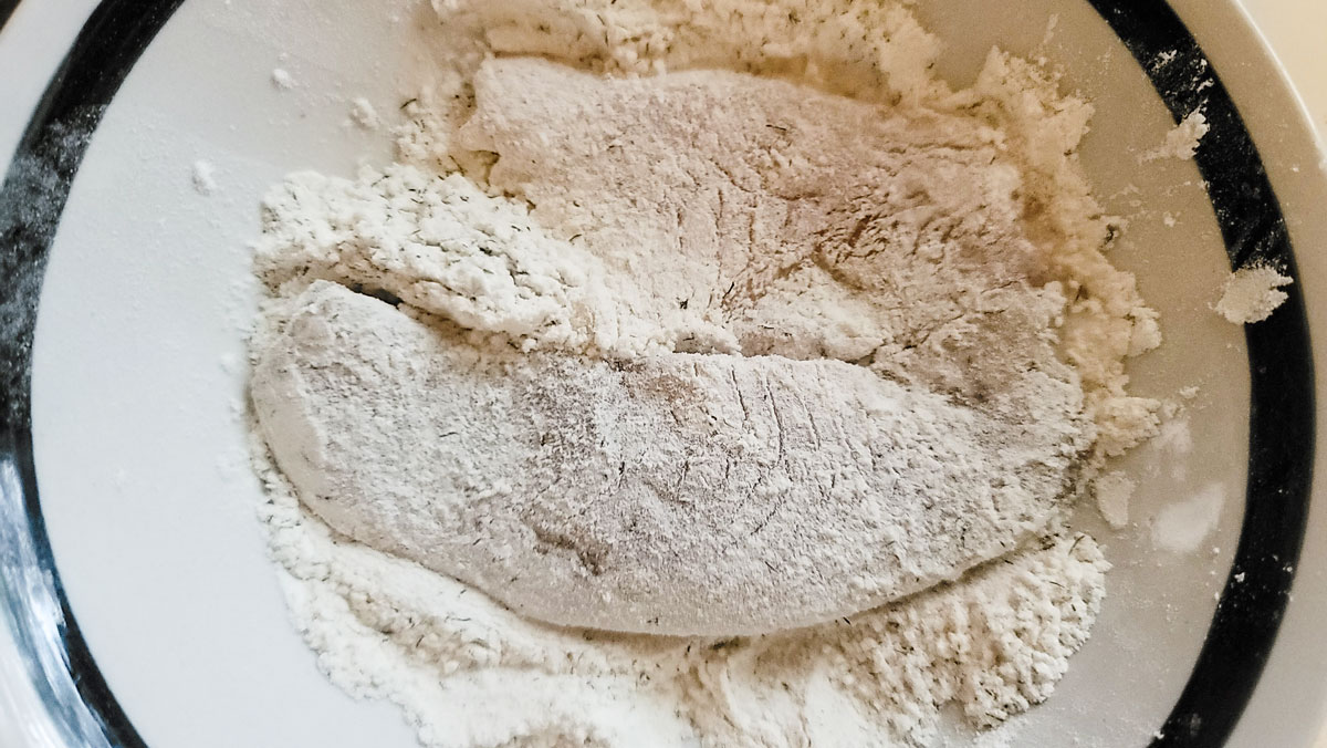 Fish in the bowl covered with flour.