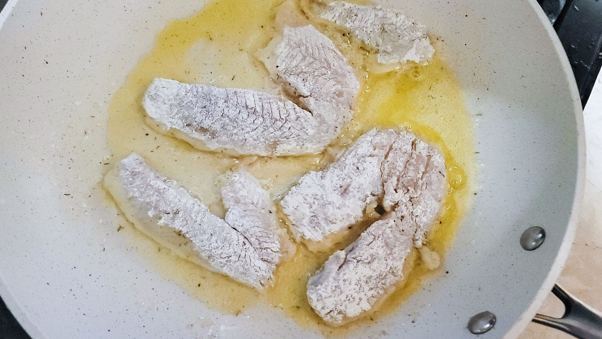 Filets sautéing in the frying pan. 