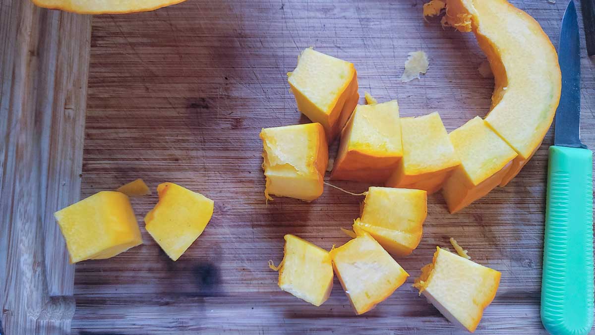 1 inch pieces of pumpkin on cutting board.