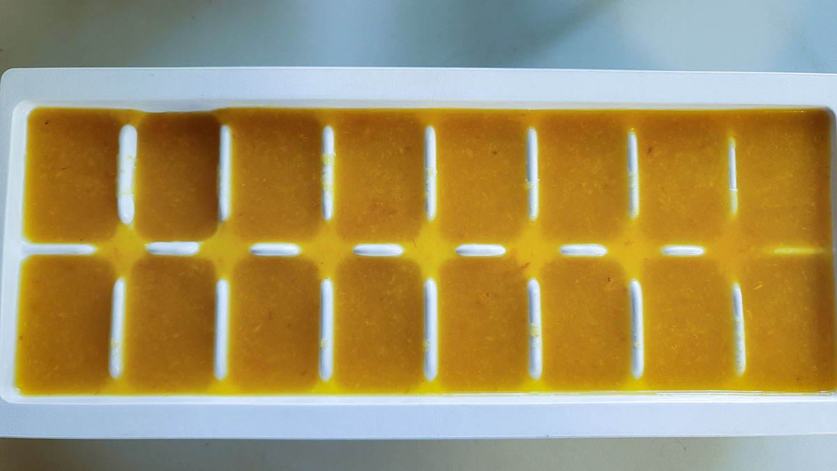 Ice tray filled with juice.