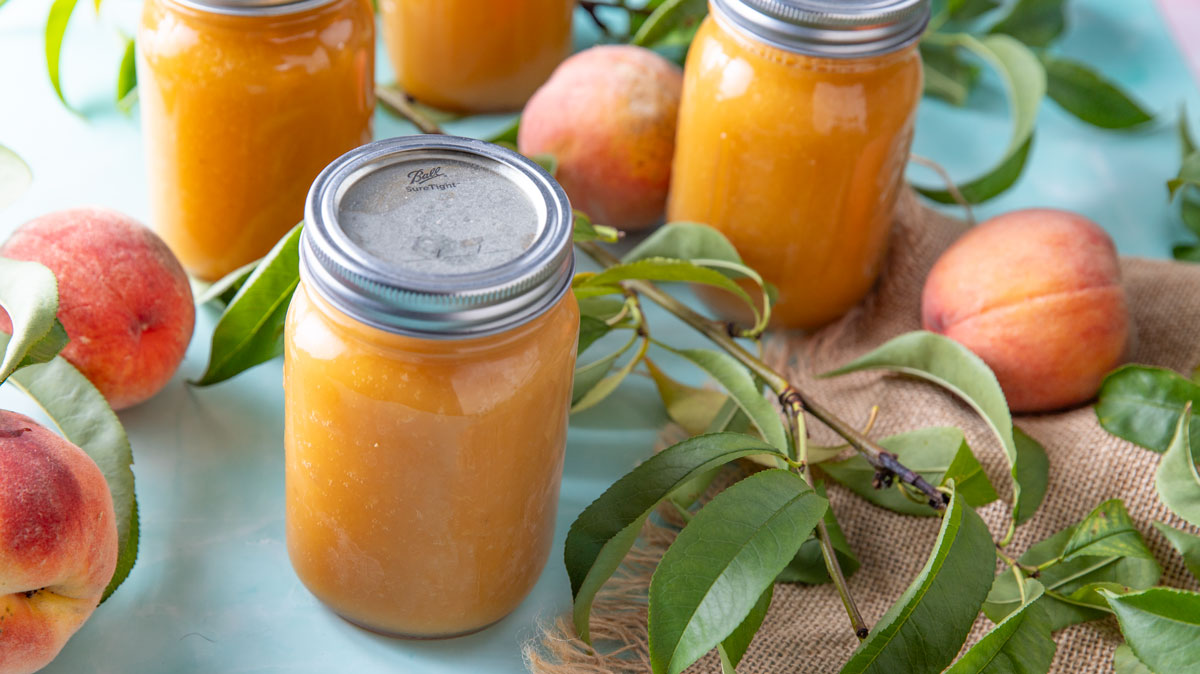 Overhead photo of peach juice in jars.