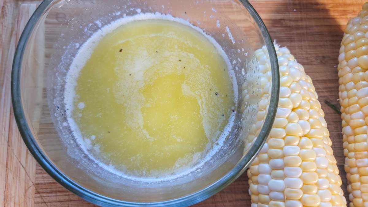 Melted butter with pepper in it in a small bowl.