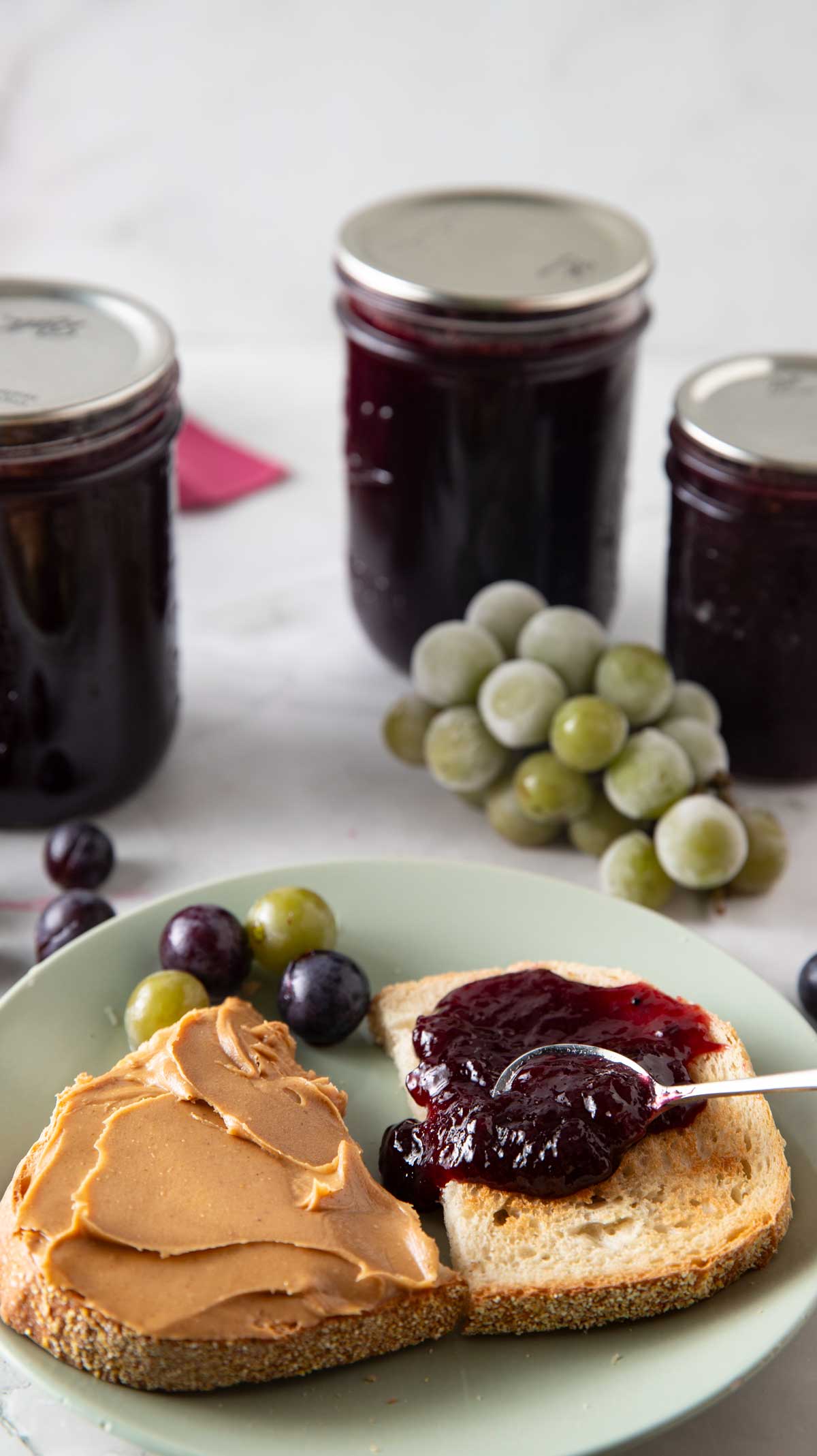 Making a peanut butter and jelly sandwich with grape jelly.