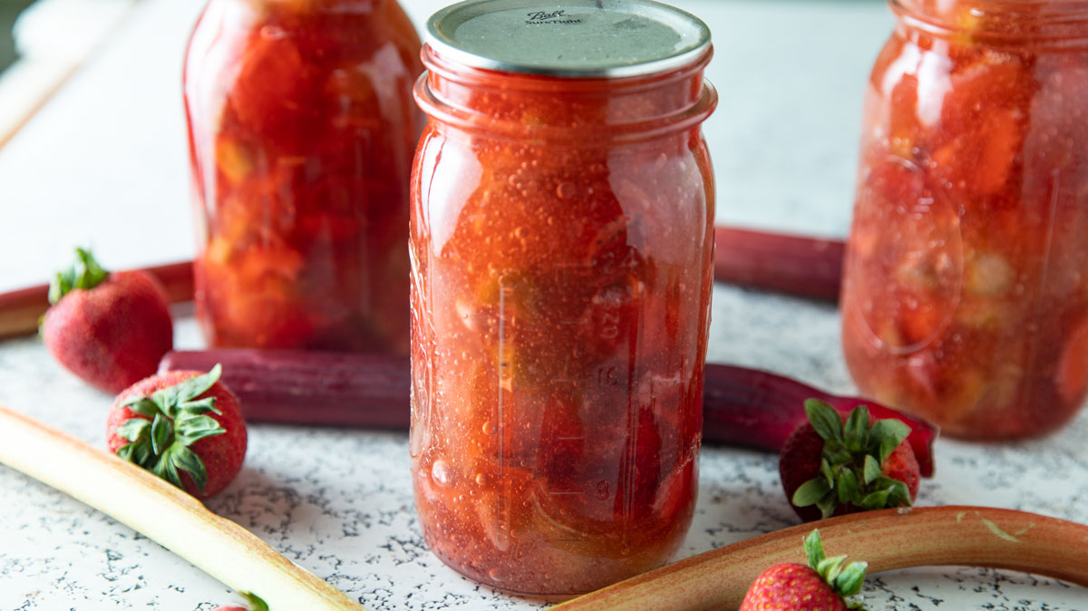 Quart jars with red pie filling.