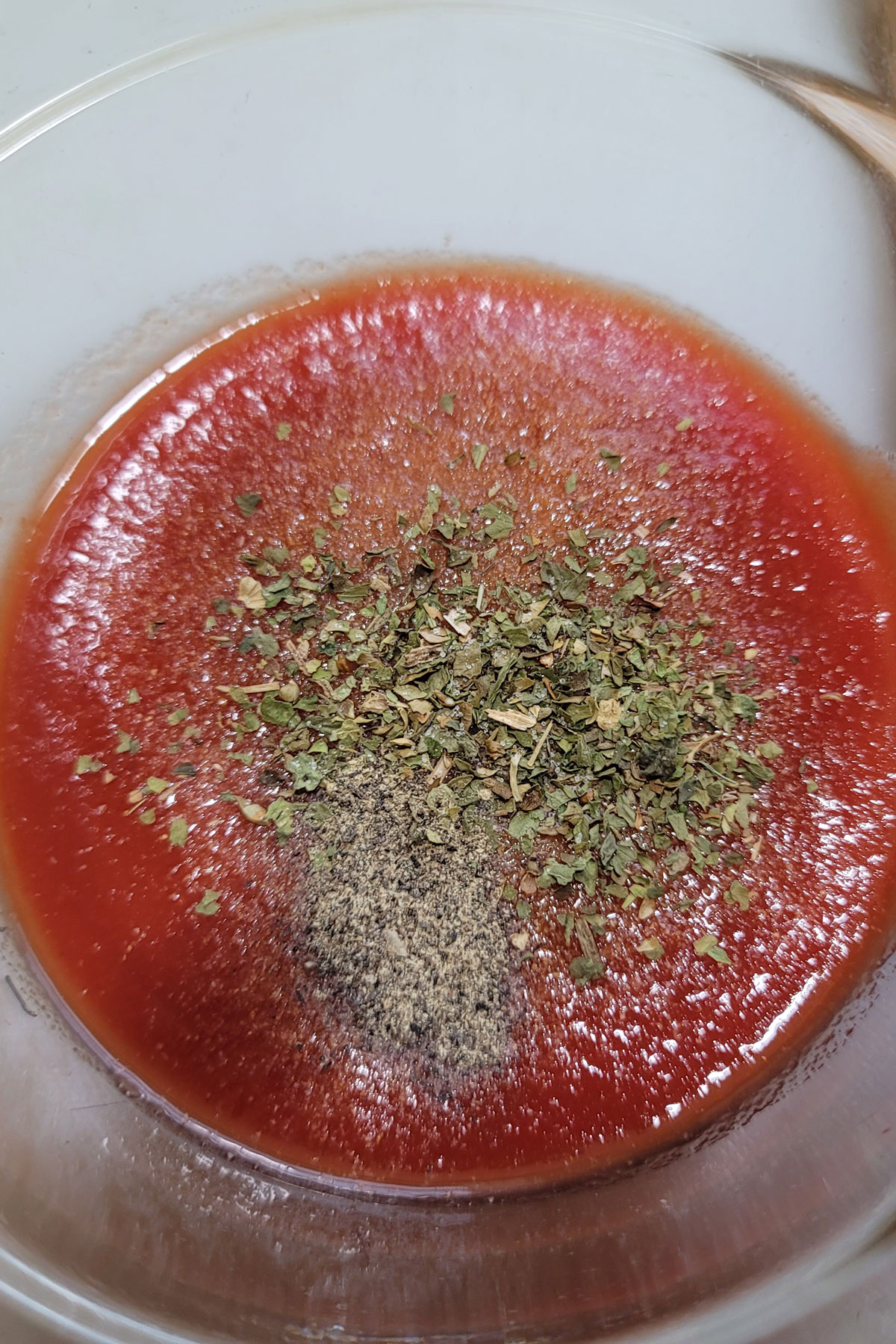 Spices added to tomato sauce.