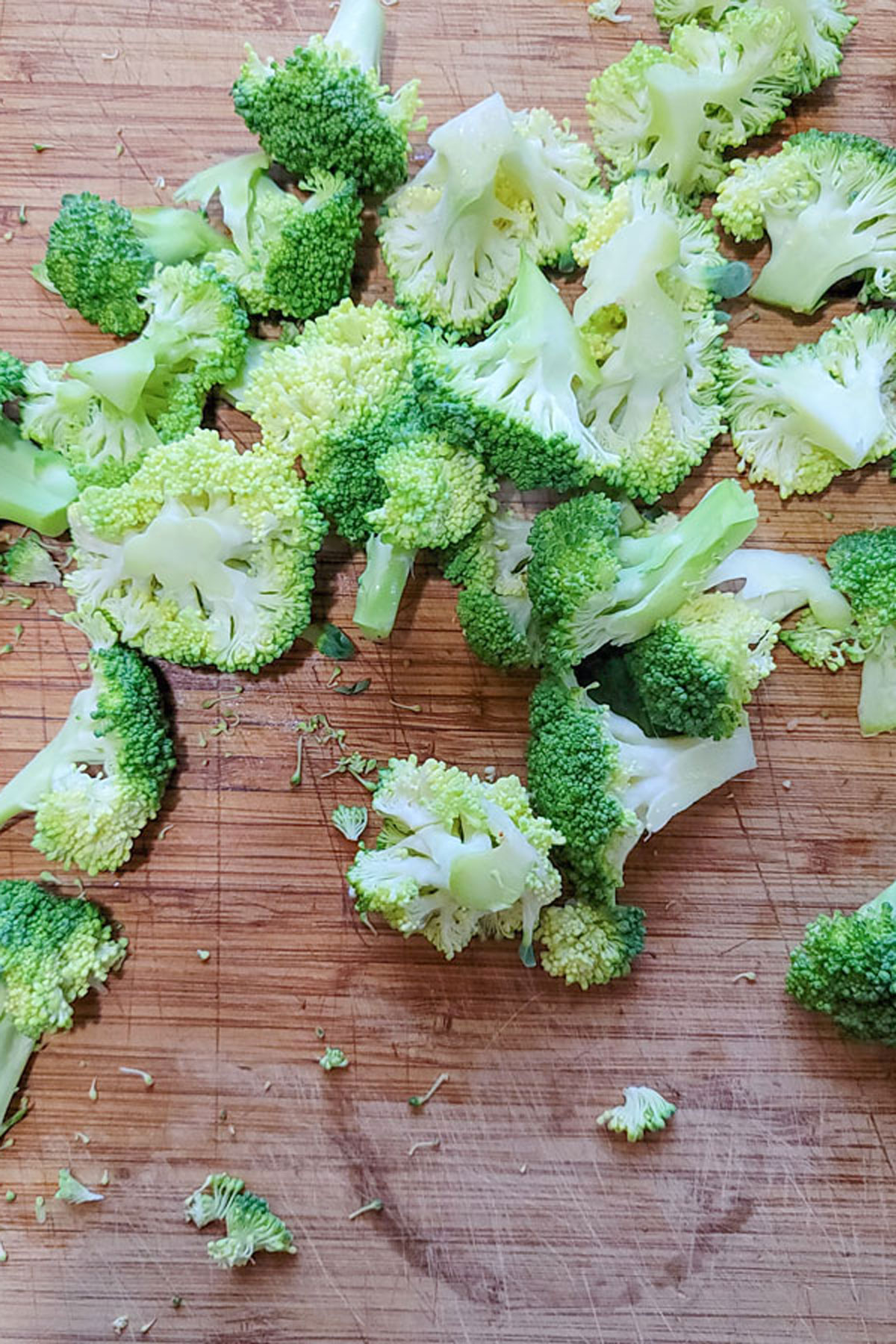 Chopped broccoli on a wooden board.