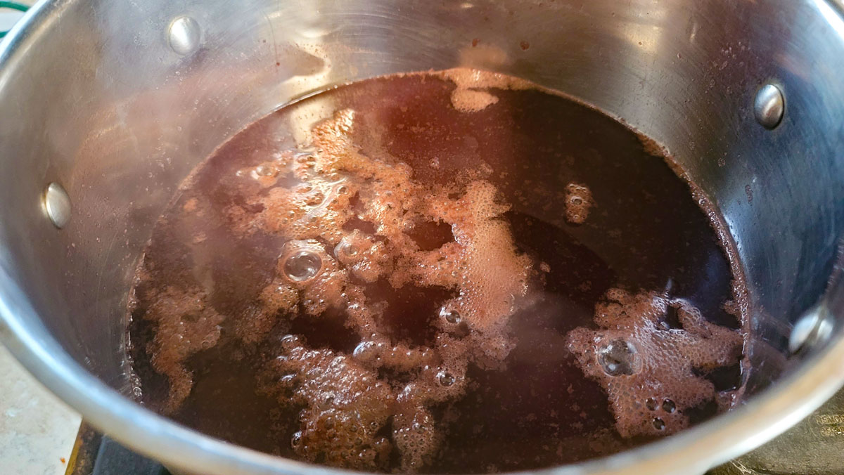 Grape juice heating in a large pot.