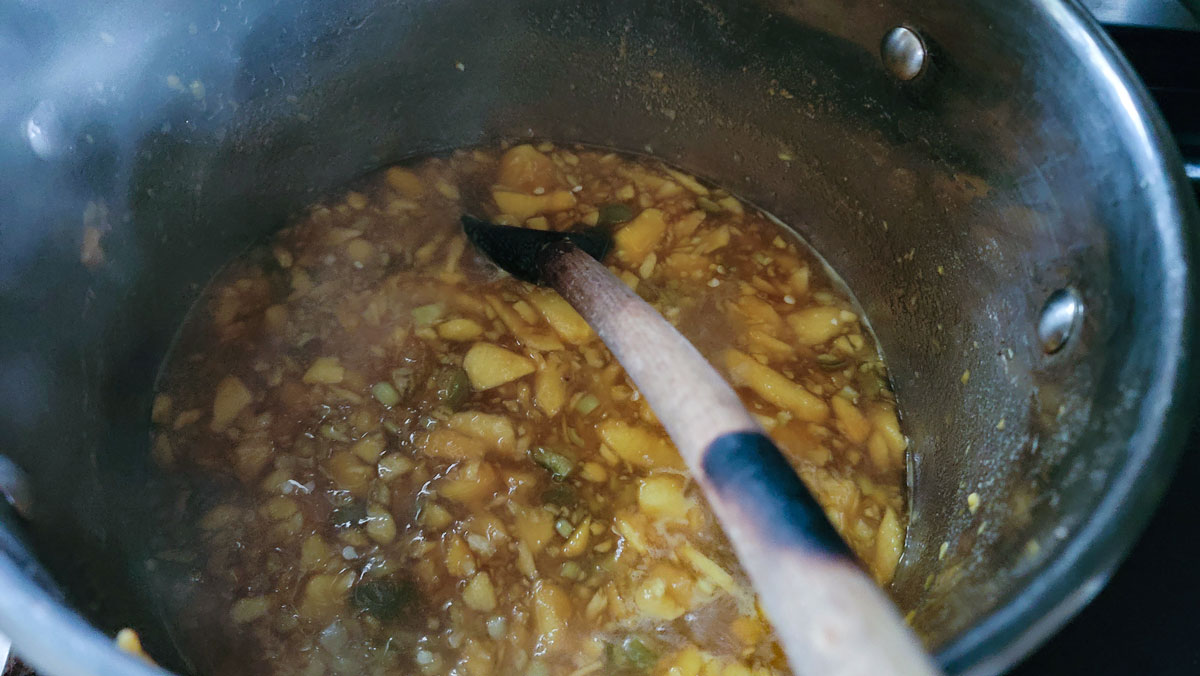 Heating the peaches and jalapenos in the pot. 