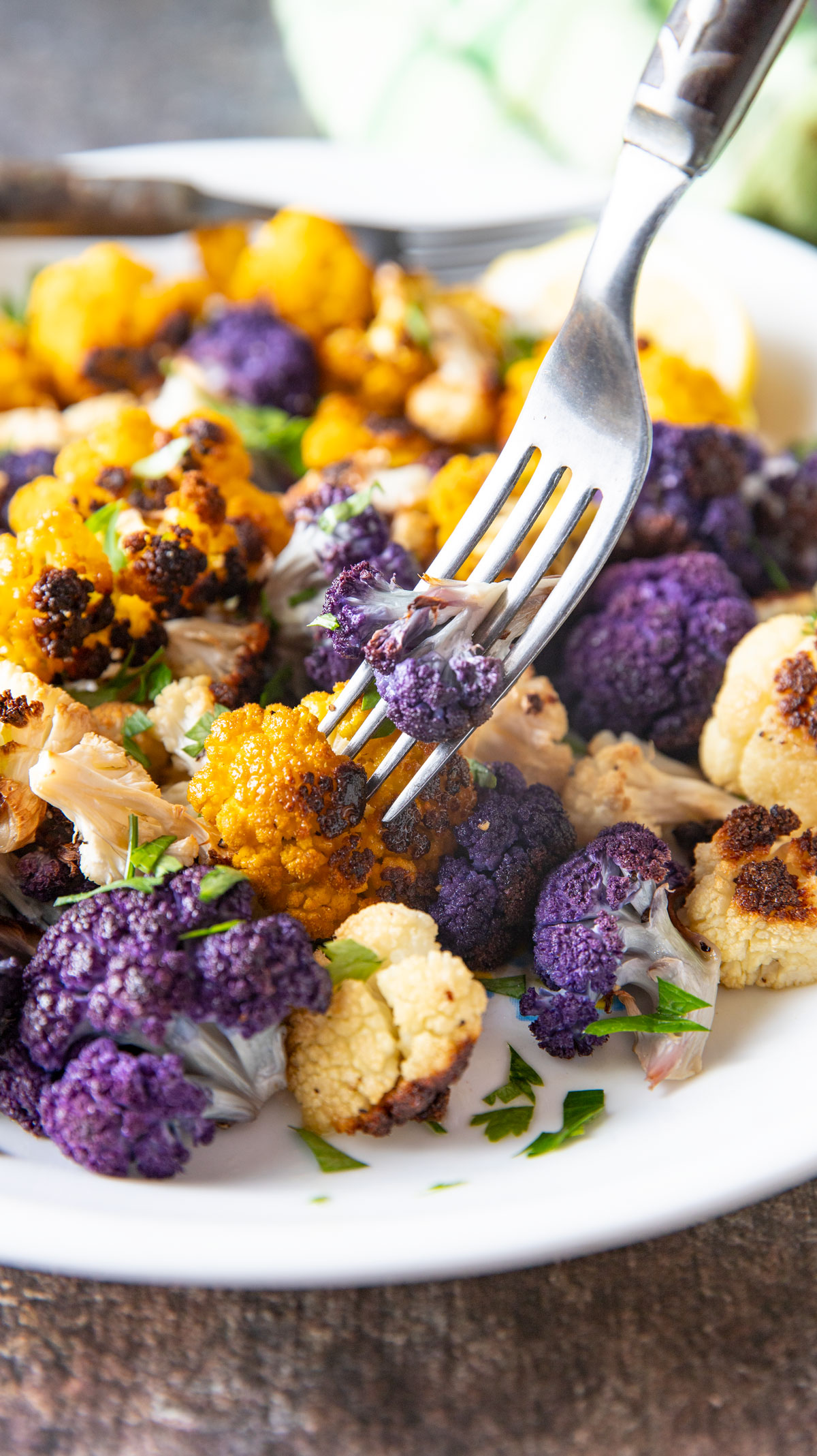 Fork spearing a piece of purple cauliflower.